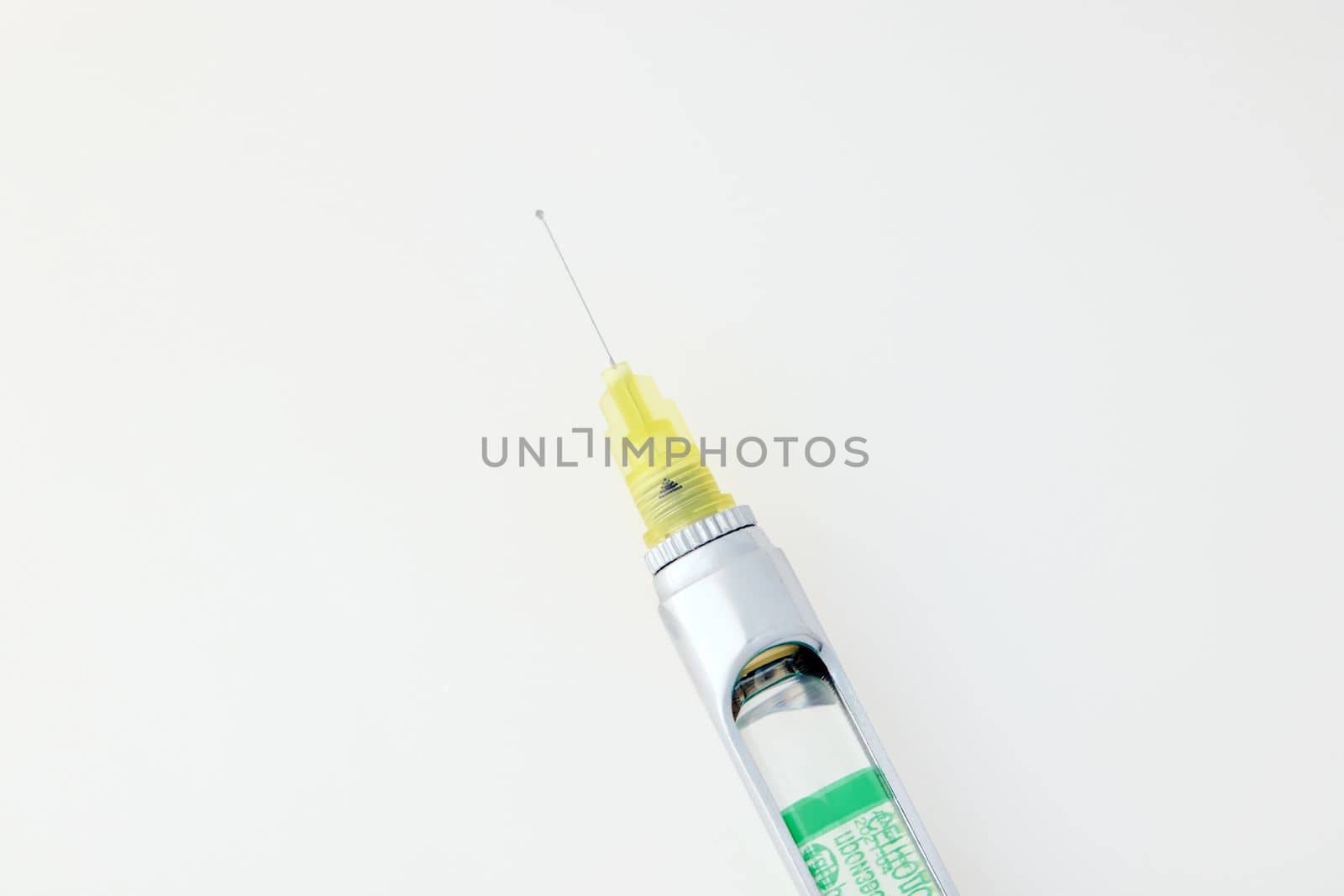 Steel dental syringe for local anesthesia, isolated on white. Carpool syringe for anesthesia in dentistry. Thin needle on a syringe for anesthesia in dentistry.
