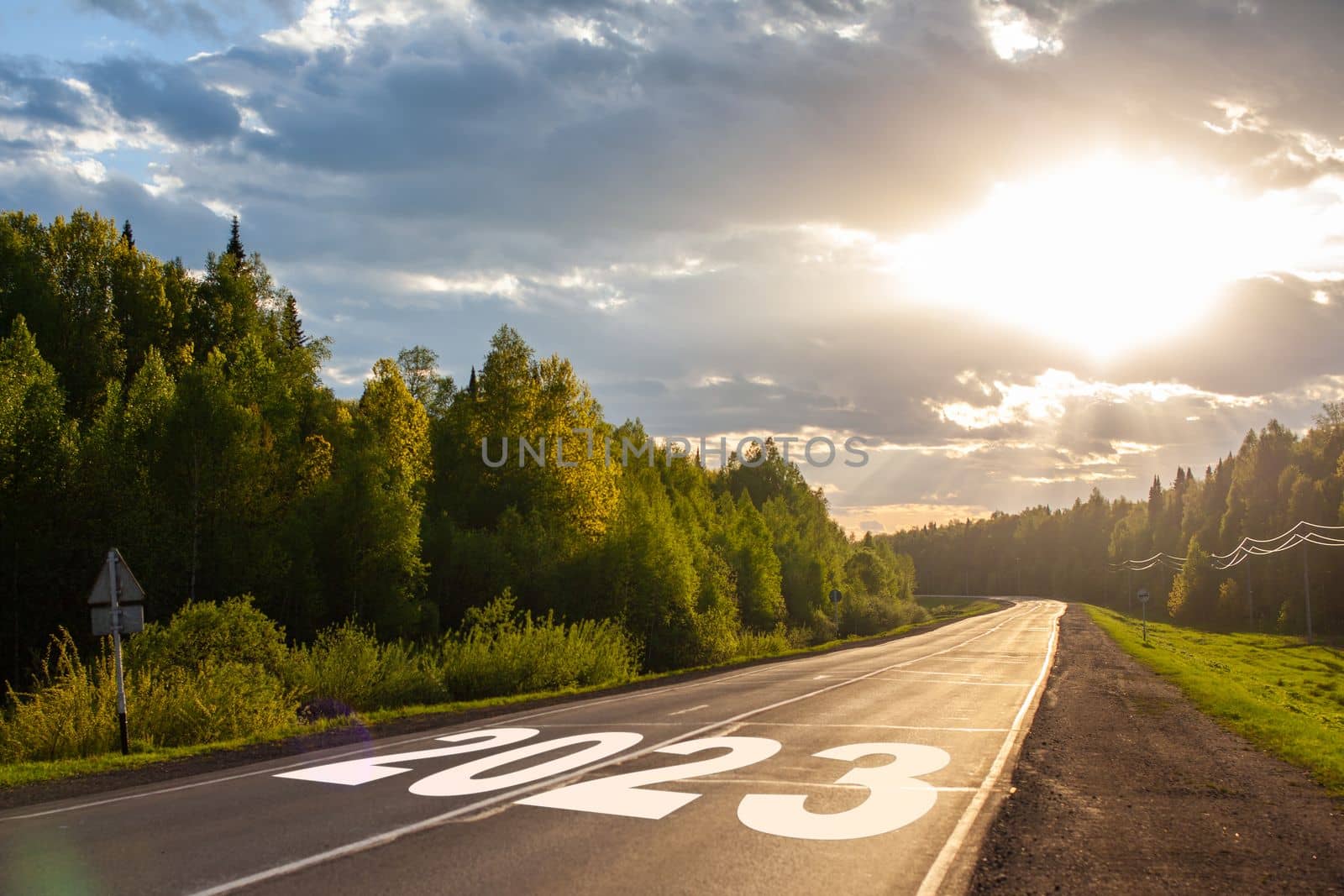 2023 written on highway road in the middle of empty asphalt road and beautiful blue sky. Concept for vision new year 2023.
