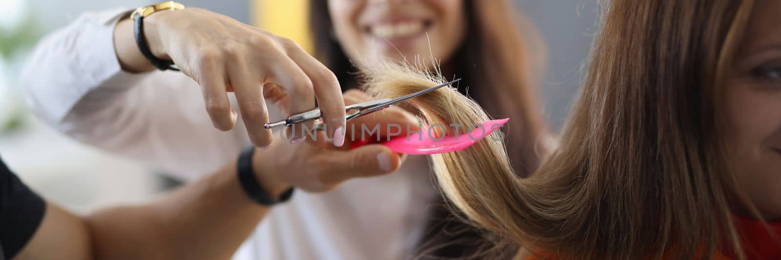 Student in hairdressing is learning how to cut hair. Training profession hairdresser concept