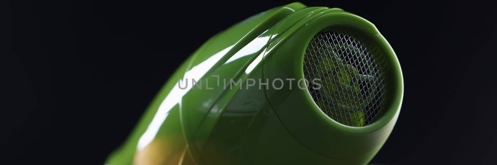 Person holds hair dryer back view and shows metal mesh covering inside of device by kuprevich