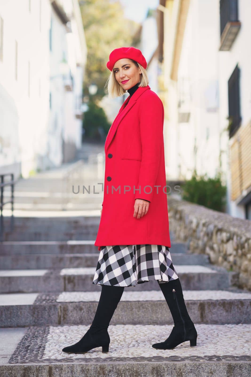 Stylish woman on stairs in city by javiindy
