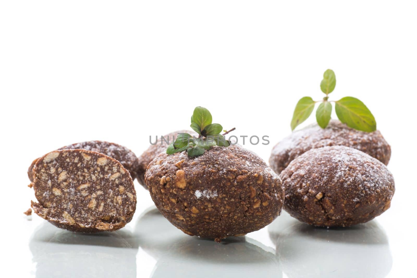 chocolate sweet cakes made from pureed biscuits with additives , isolated on white background .