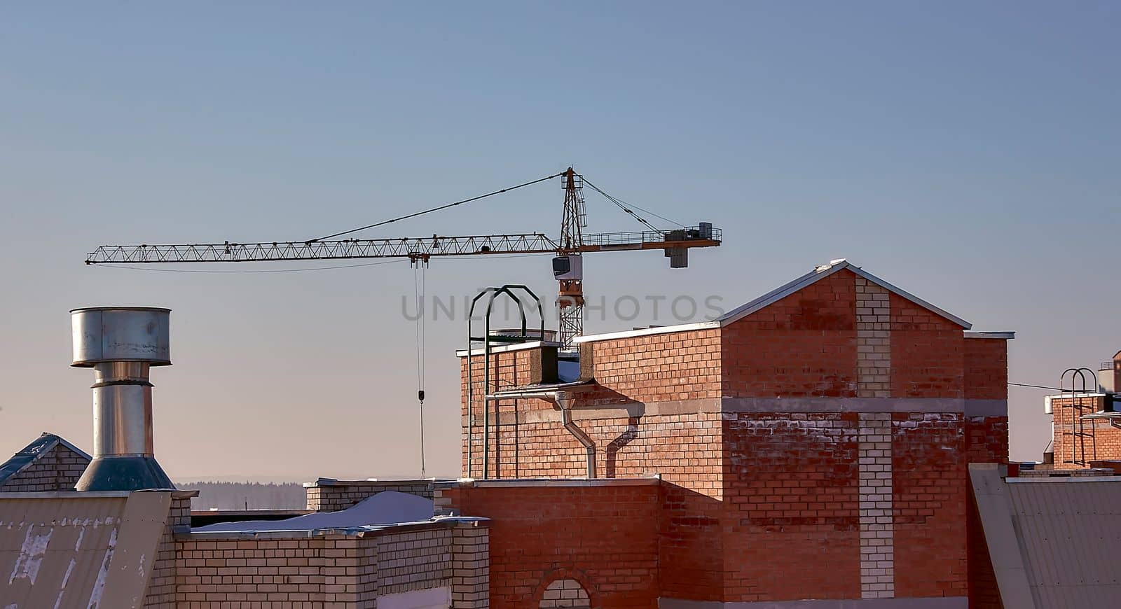 construction site and sunset in winter, structural steel beam builds large residential buildings on the construction site.