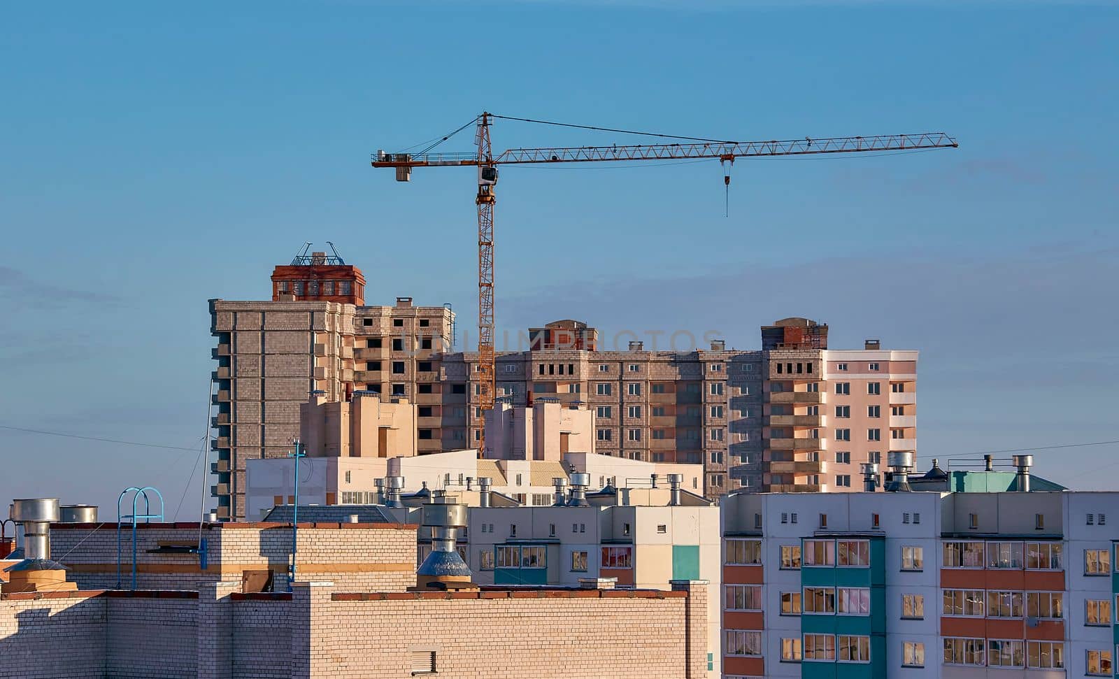 construction site and sunset in winter, structural steel beam builds large residential buildings on the construction site.