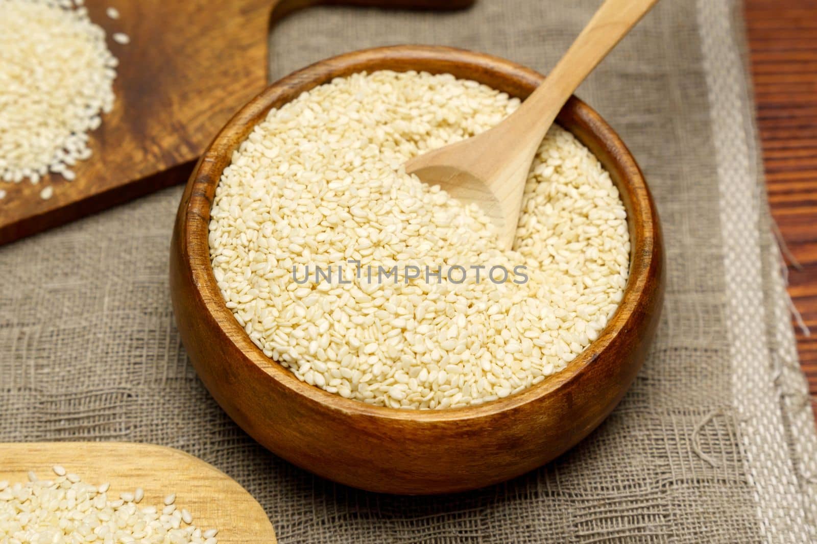 Healthy food and drink concept. Sesame seeds in a bowl on a rustic table. Selective focus