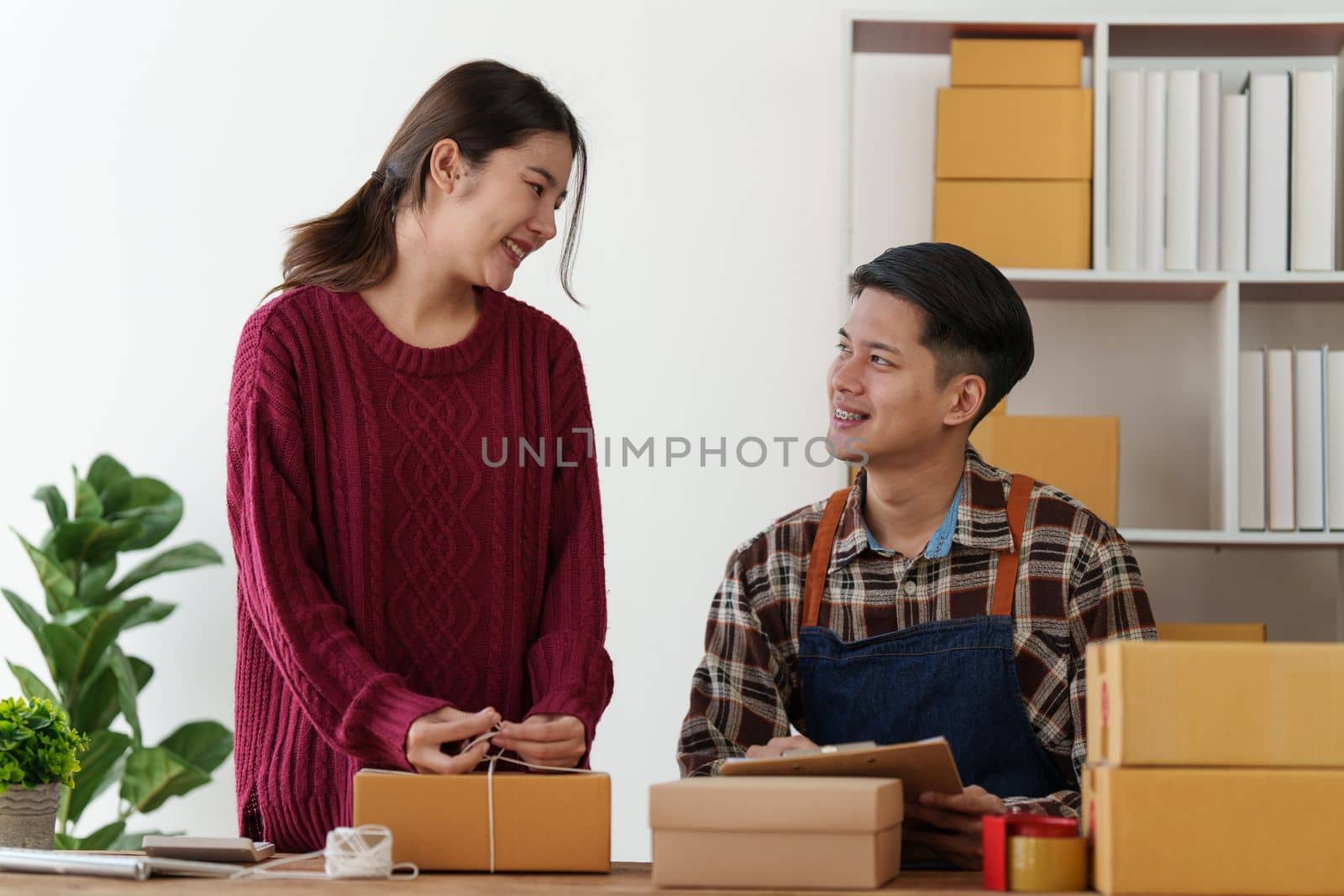 Asian couple doing business online. Entrepreneurs, small SME businesses concept. by itchaznong
