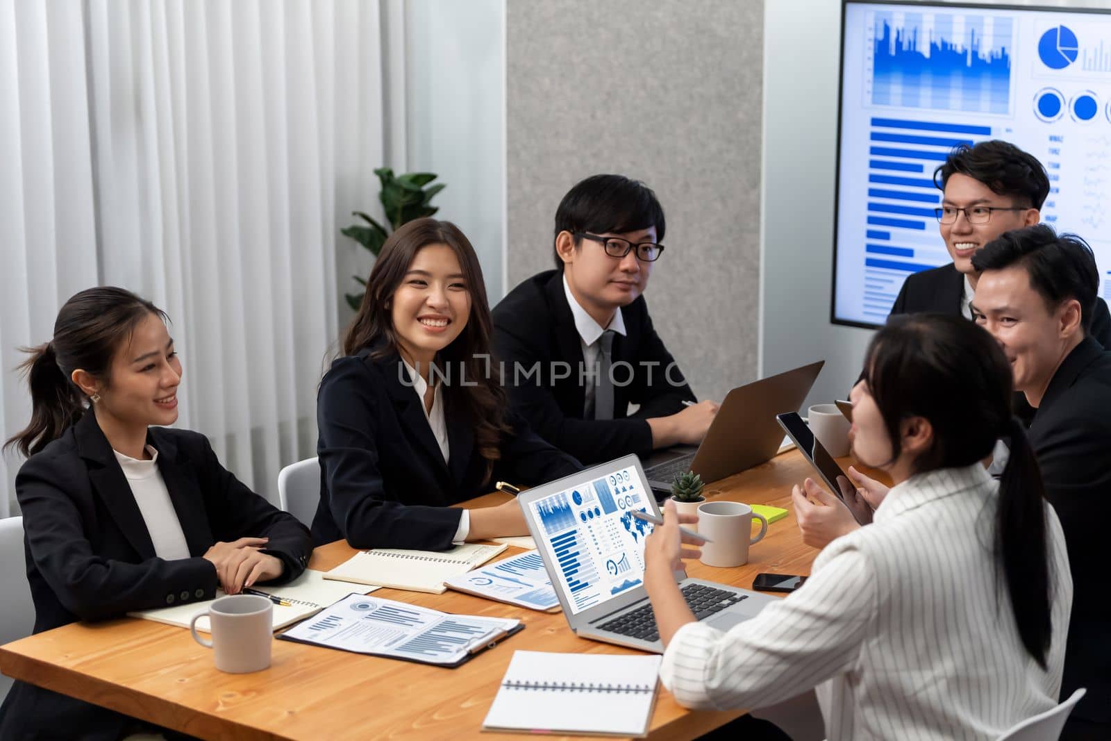 Business team of financial data analysis meeting with business intelligence, report paper and dashboard on laptop for marketing strategy. Business people working together to promote harmony in office.