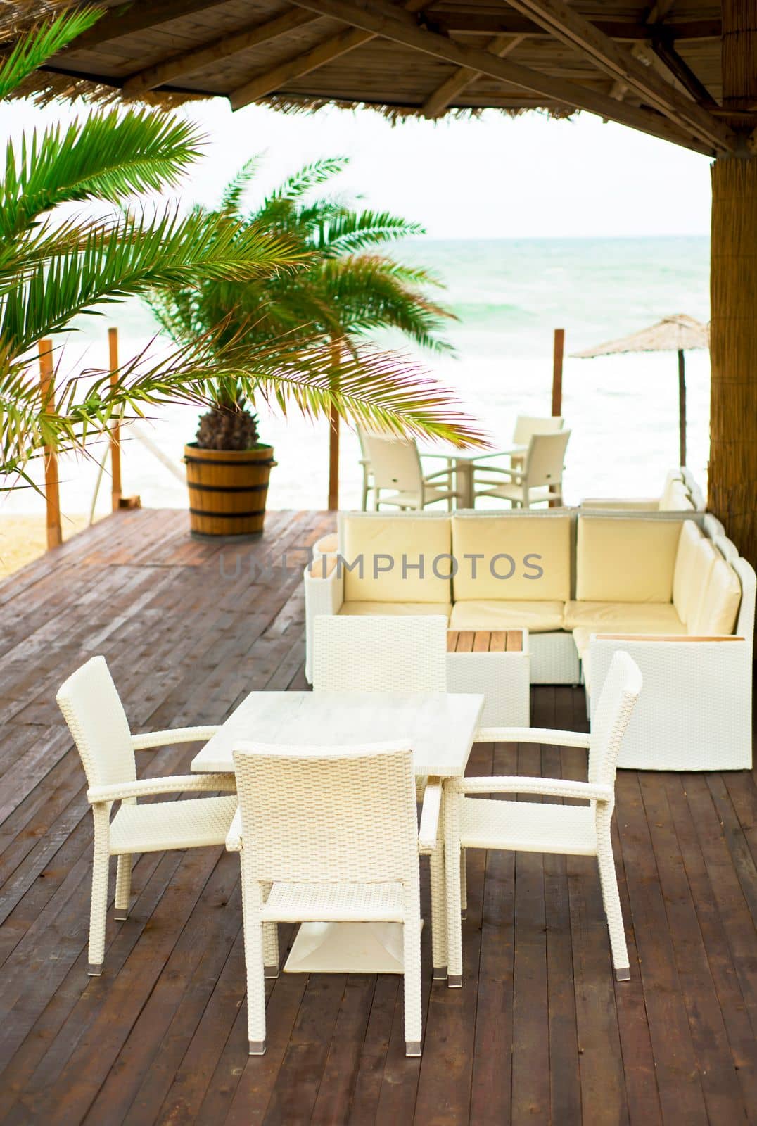 Bad weather. Storm. There are no people in the cafe on the beach. Empty beaches in Bulgaria next to the stormy sea by aprilphoto