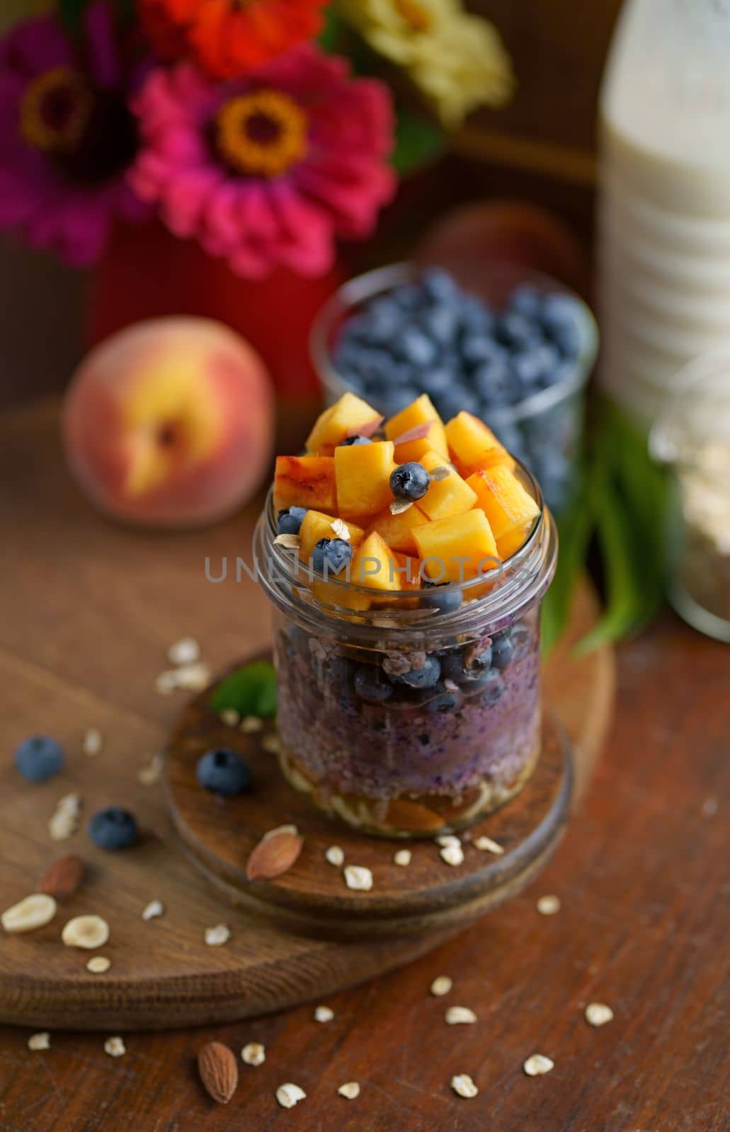 Breakfast yogurt granola parfait with peach and blueberry in a jar, healthy food, clean eating concept by aprilphoto