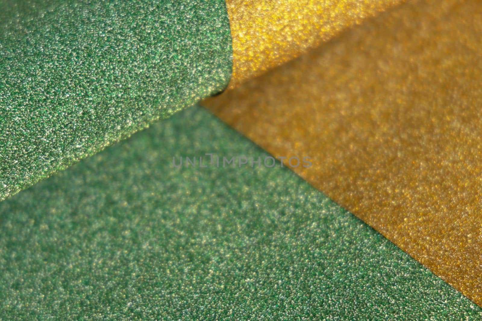 Golden and green wave shiny glitter paper texture. Shining luxurious fabric. Glimmering light green golden color, christmas background. by Ri6ka