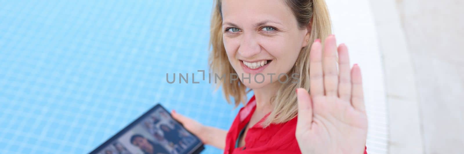 Happy smiling female boss holding online meeting on tablet by pool. Remote work control and telework for freelancers