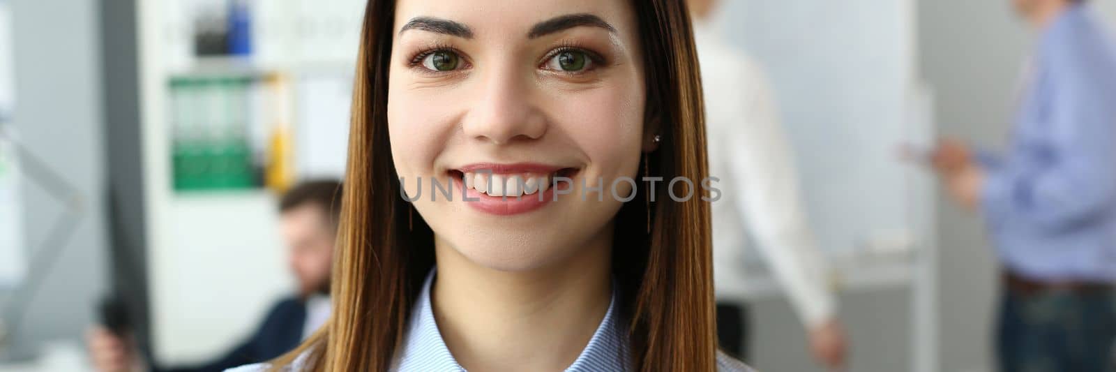 Portrait of a beautiful woman on background of business people by kuprevich