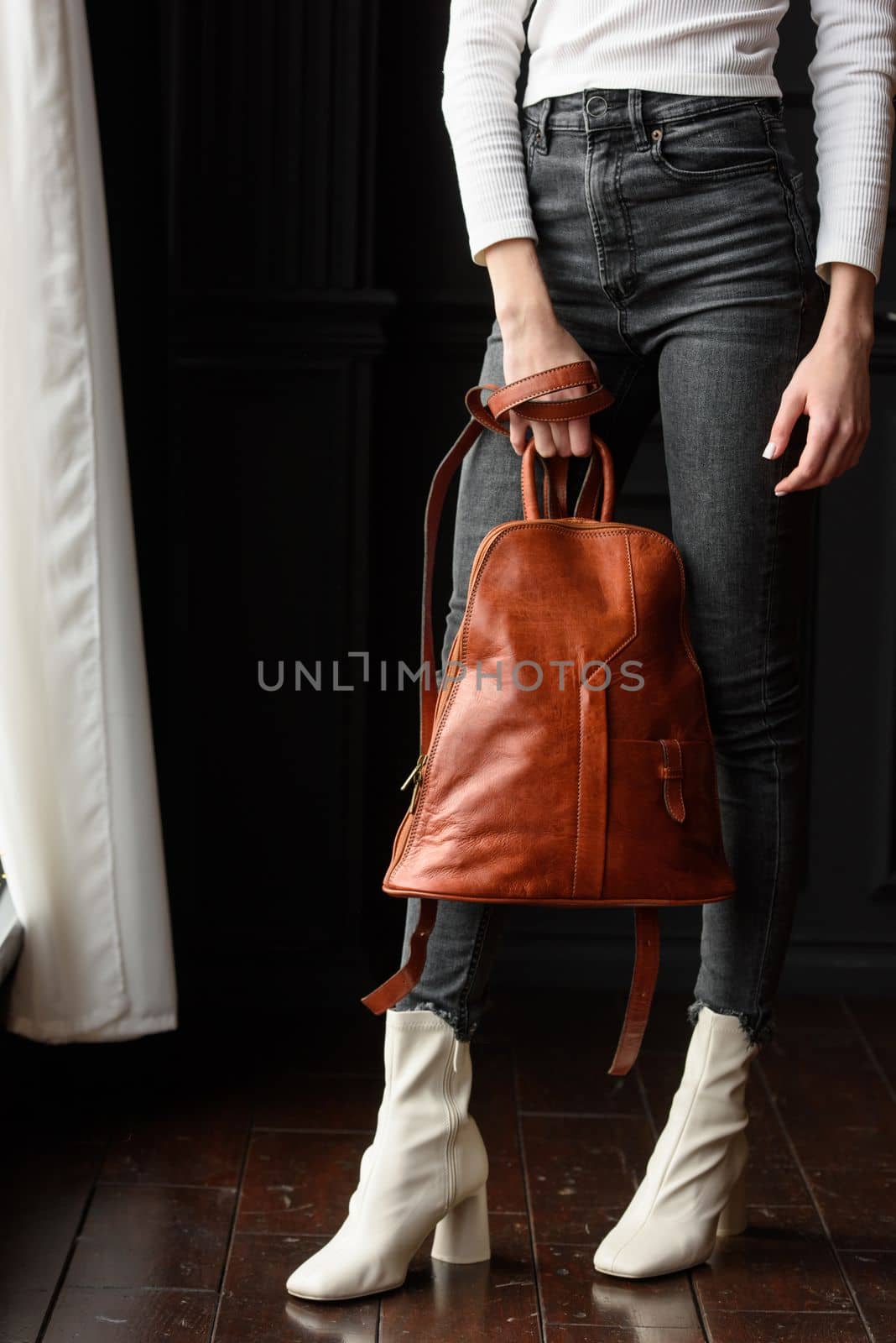 photo of a woman with a orange leather backpack . indoors photo by Ashtray25
