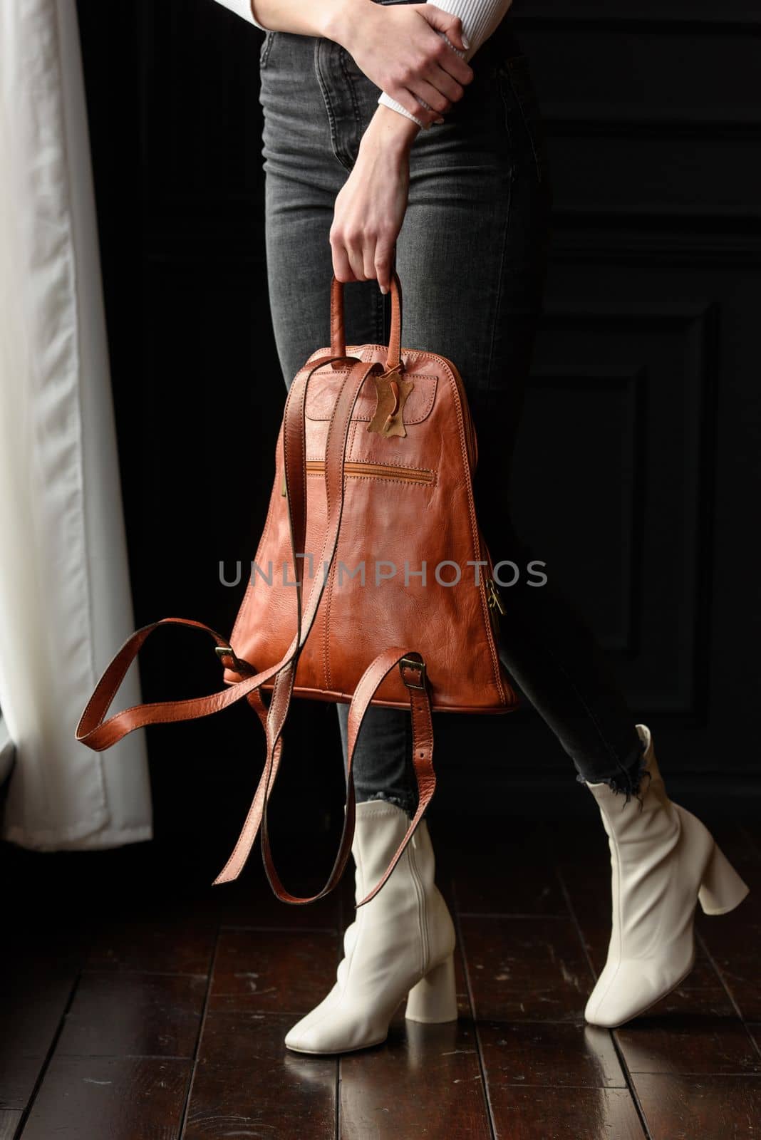 photo of a woman with a orange leather backpack . indoors photo by Ashtray25