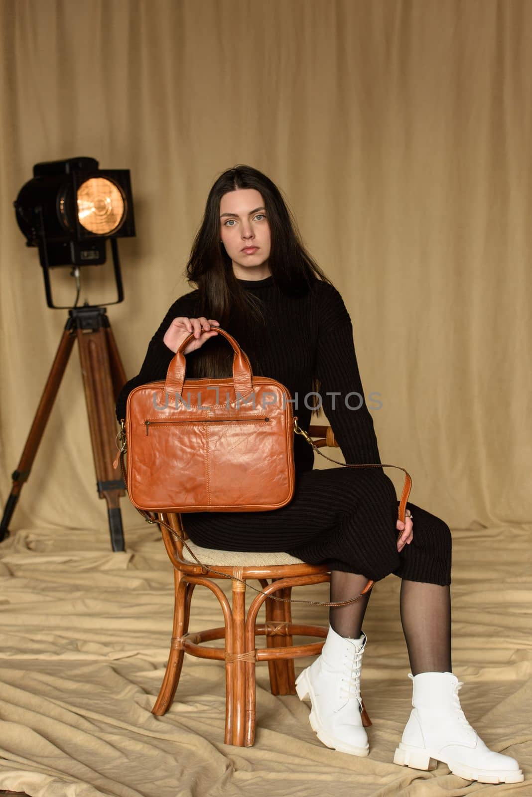photo of a woman with a orange leather back with antique and retro look. indoors photo by Ashtray25