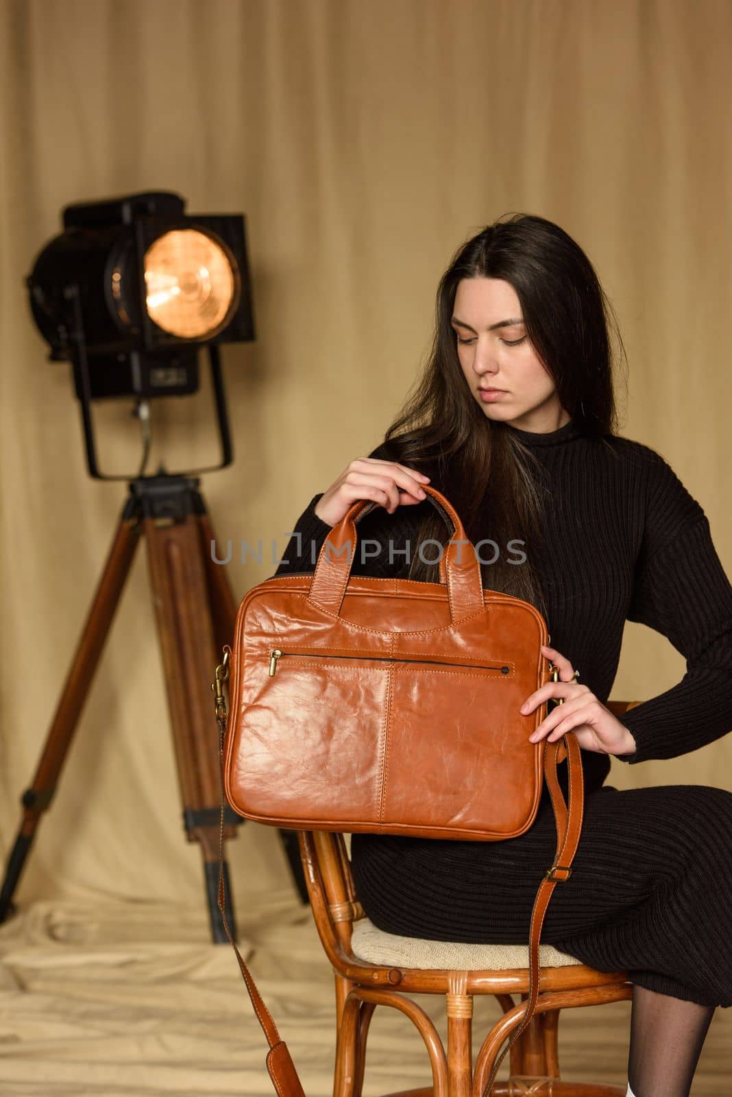 photo of a woman with a orange leather backpack with antique and retro look. indoors photo by Ashtray25