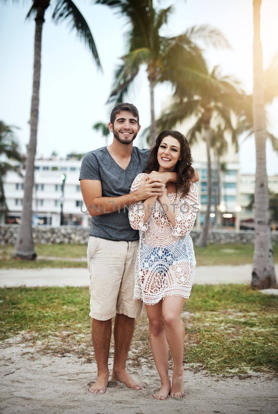 Its summer, time for a baecation. a young couple spending a romantic day at the beach. by YuriArcurs