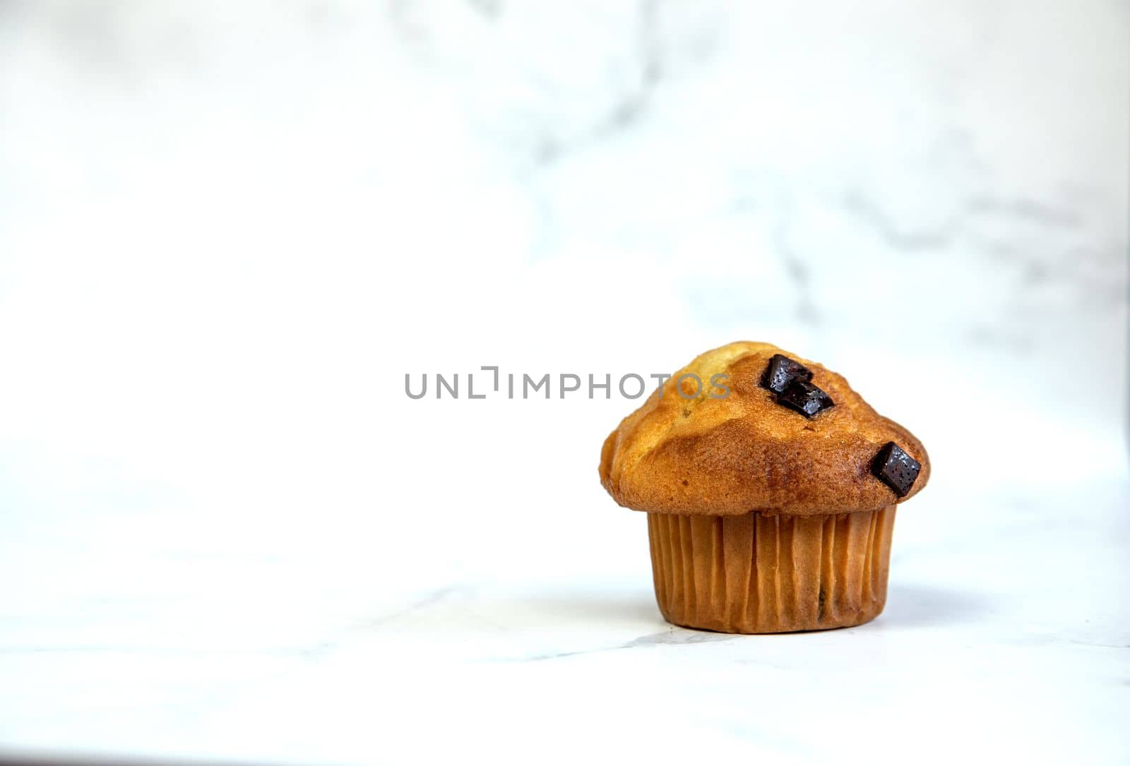 A stack of delicious chocolatechip banana muffins and blueberries on a white background, tasty healthy snack granola breakfast muffin food