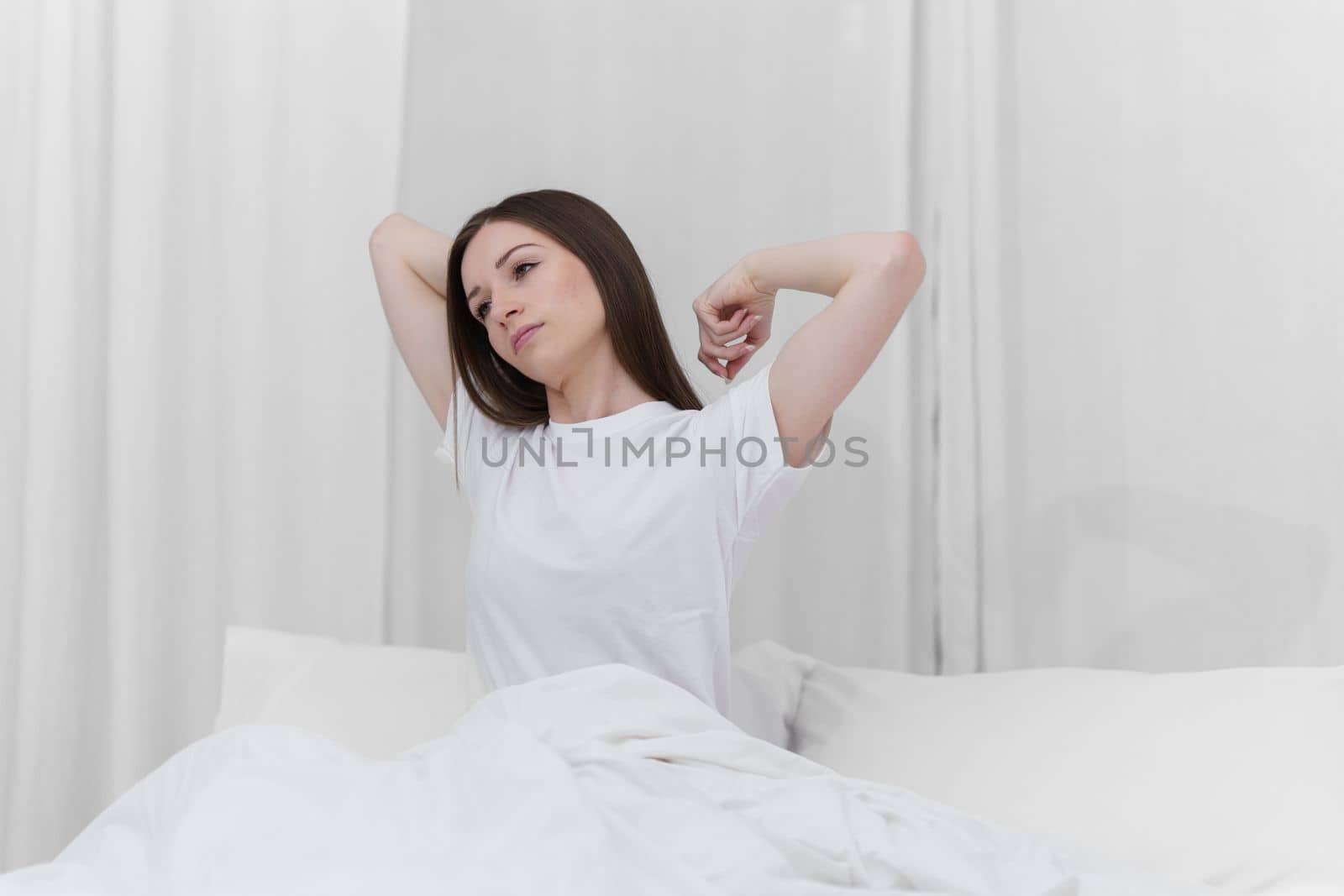 Image of beautiful young woman resting in bed at bedroom. Lifestyle at home concept.