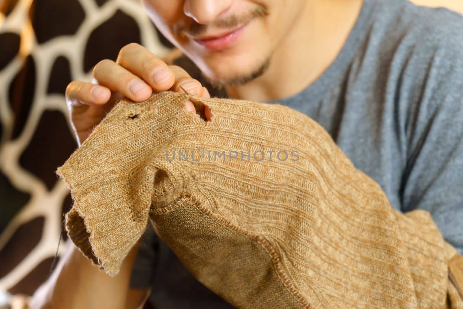 Mending clothes. Old worn woolen clothes. Repair concept, selective focus by darksoul72