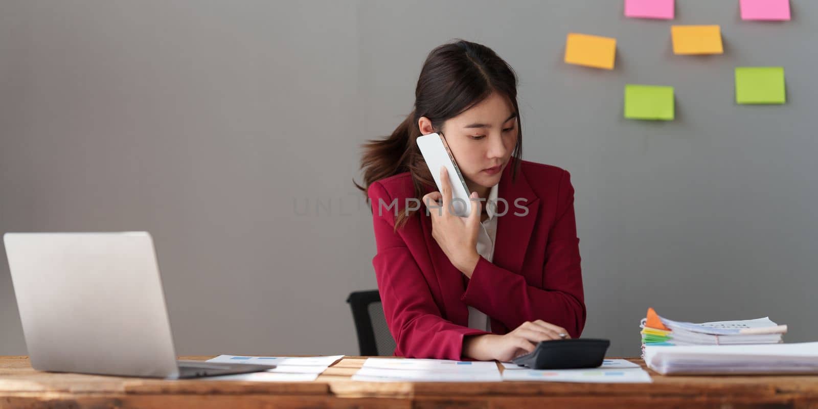 Beautiful business woman talking on the mobile phone. Management, planning and networking phone call concept. by itchaznong