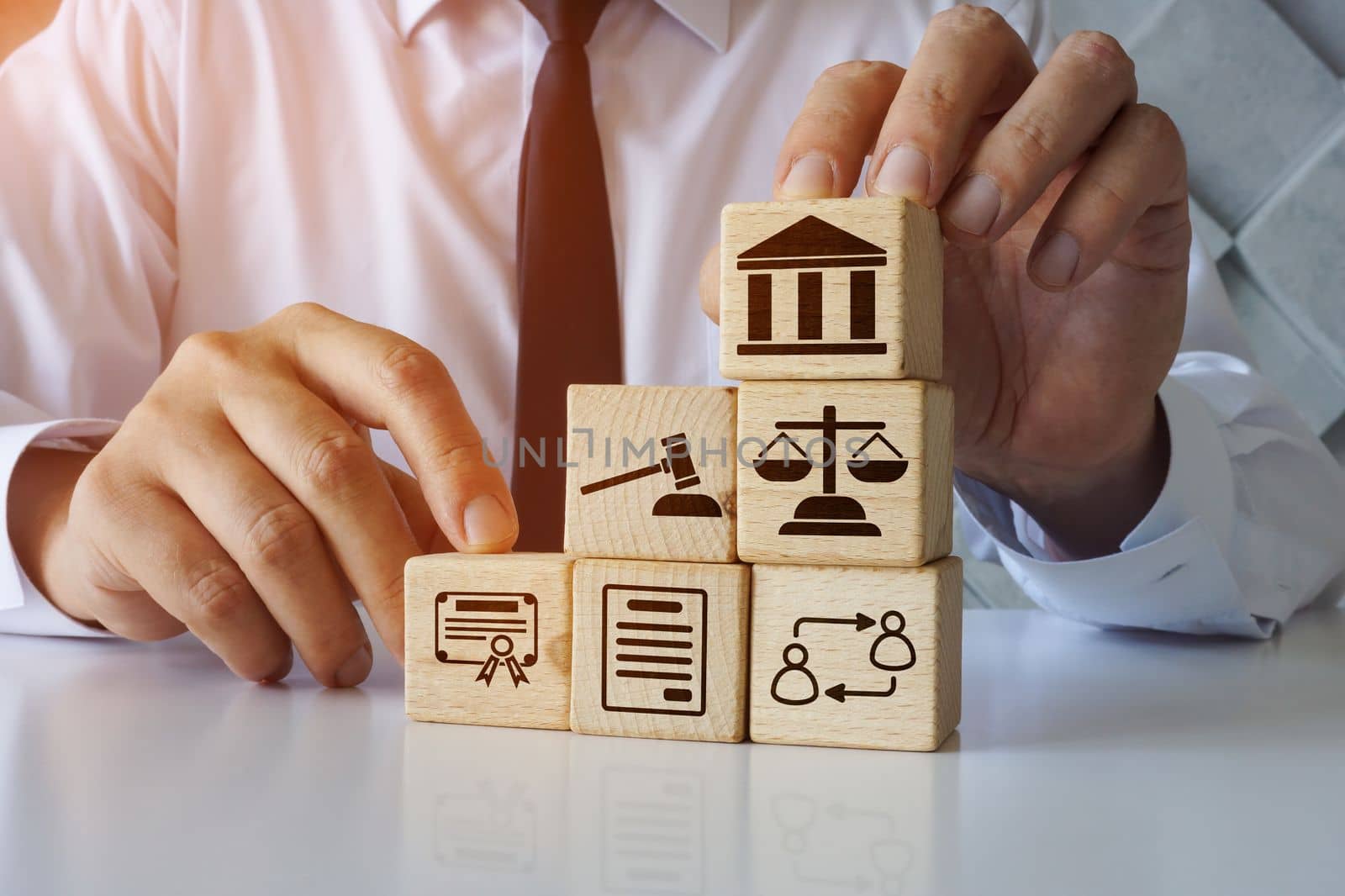 Lawyer holds cubes about business law.