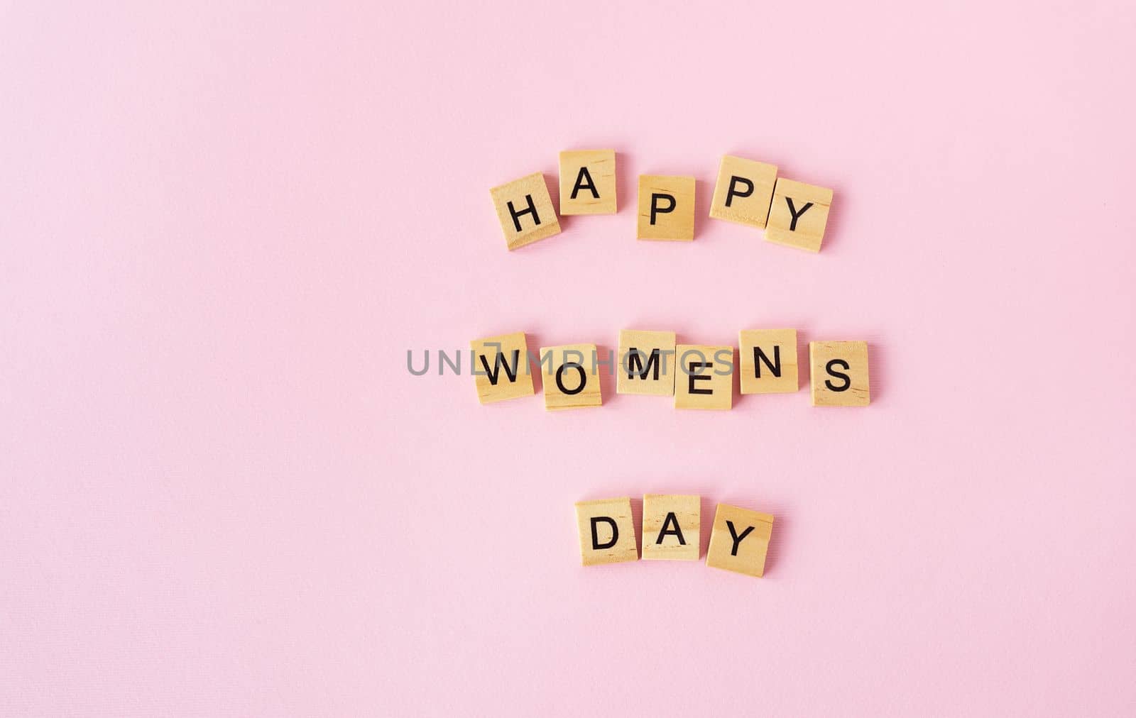 March 8, postcard. Text sign from wooden letters Happy Women's Day on a pink background. Stylish flat lay, greeting card