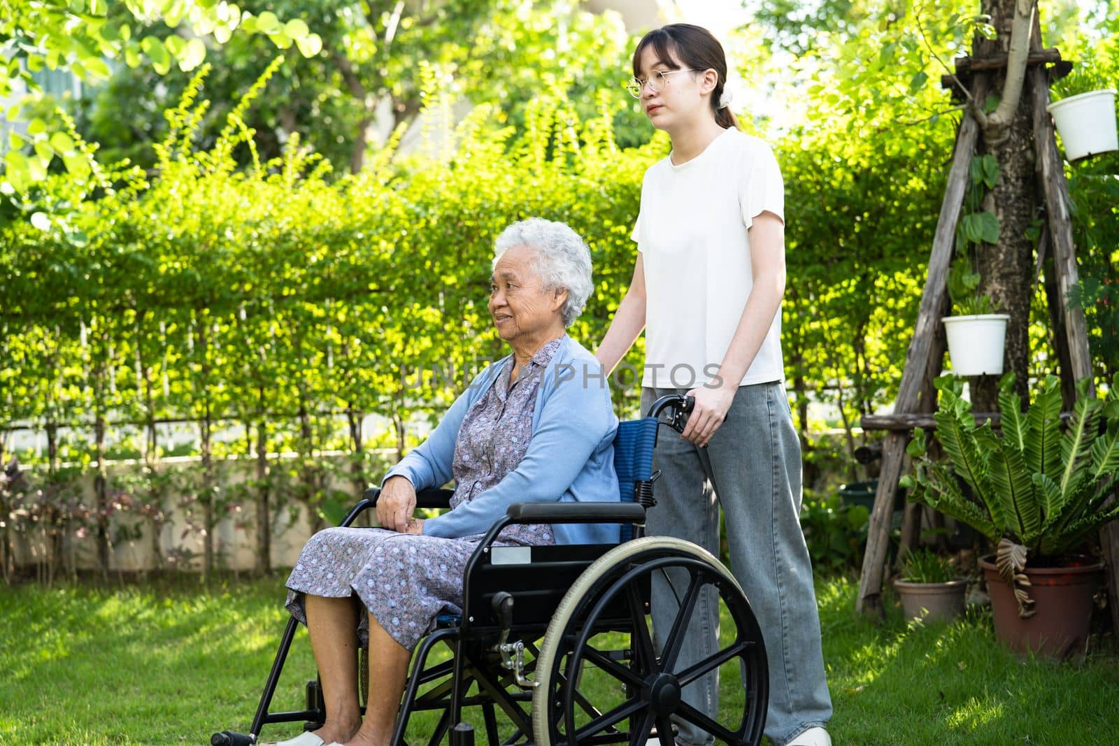 caregiver help and care Asian senior woman patient sitting on wheelchair at nursing hospital ward, healthy strong medical concept. by pamai