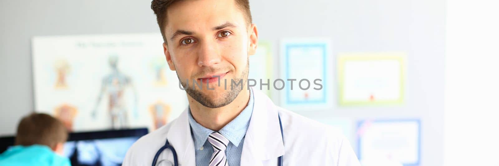 Young confident male therapist doctor cardiologist portrait by kuprevich