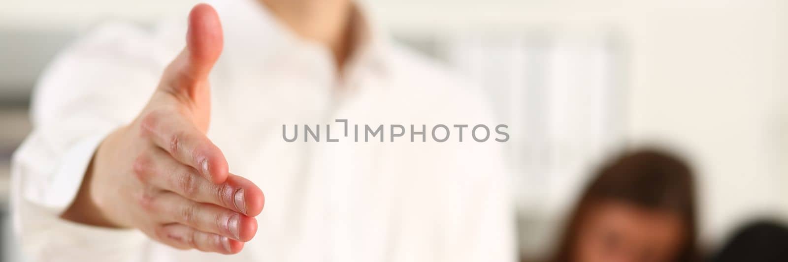 Business man intern with clipboard shaking hands. Business greeting and handshake concept