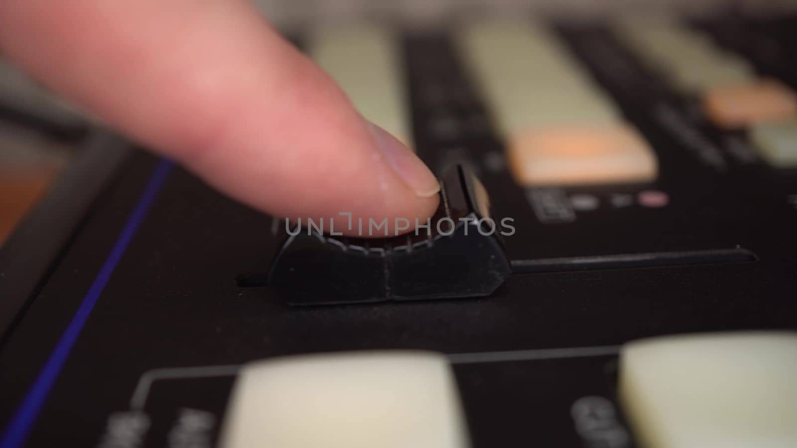 Professional analog video mixer. Camera control panel close-up. A man moves a fader on a control panel. 4k