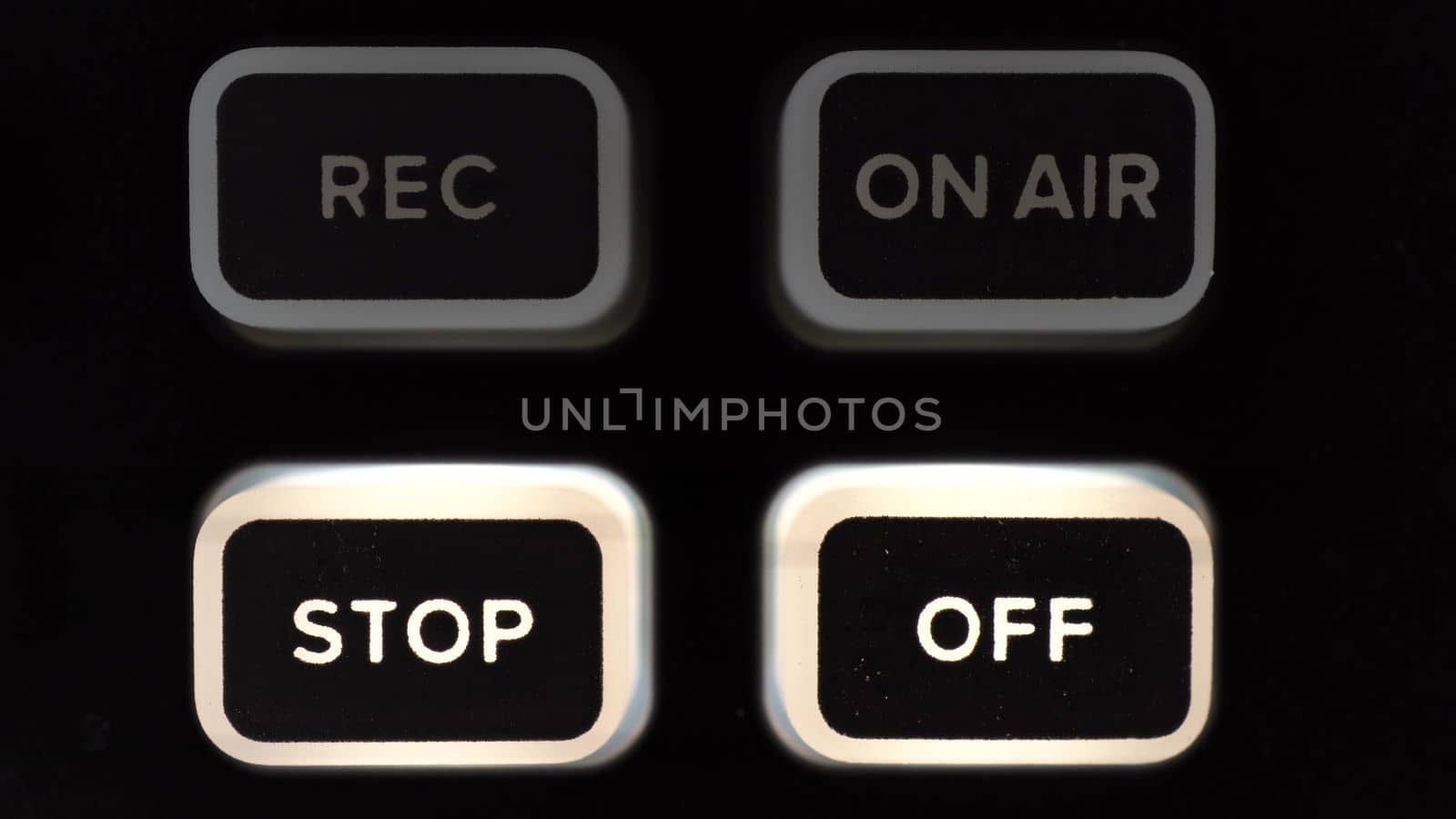 A person presses the button to turn off the broadcast. The button lights up in white. Super macro. 4k