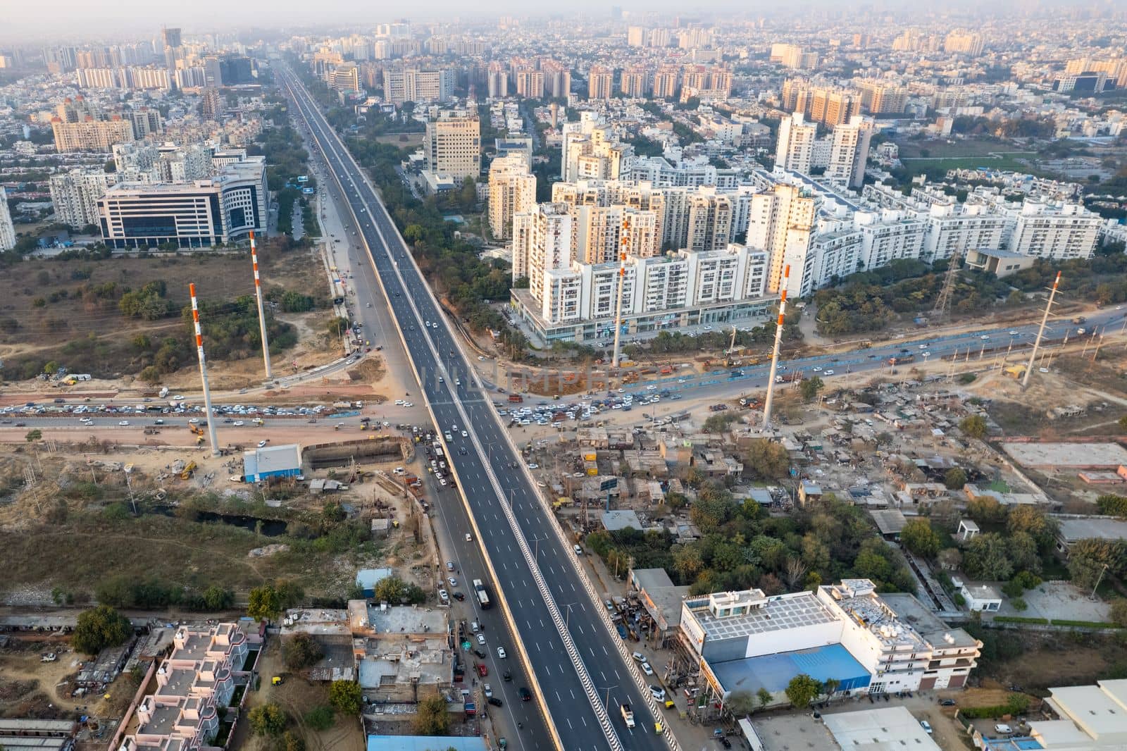 aerial drone still shot showing busy sohna elevated highway toll road with traffic stuck at interesction due to road construction of bridge or underpass by Shalinimathur