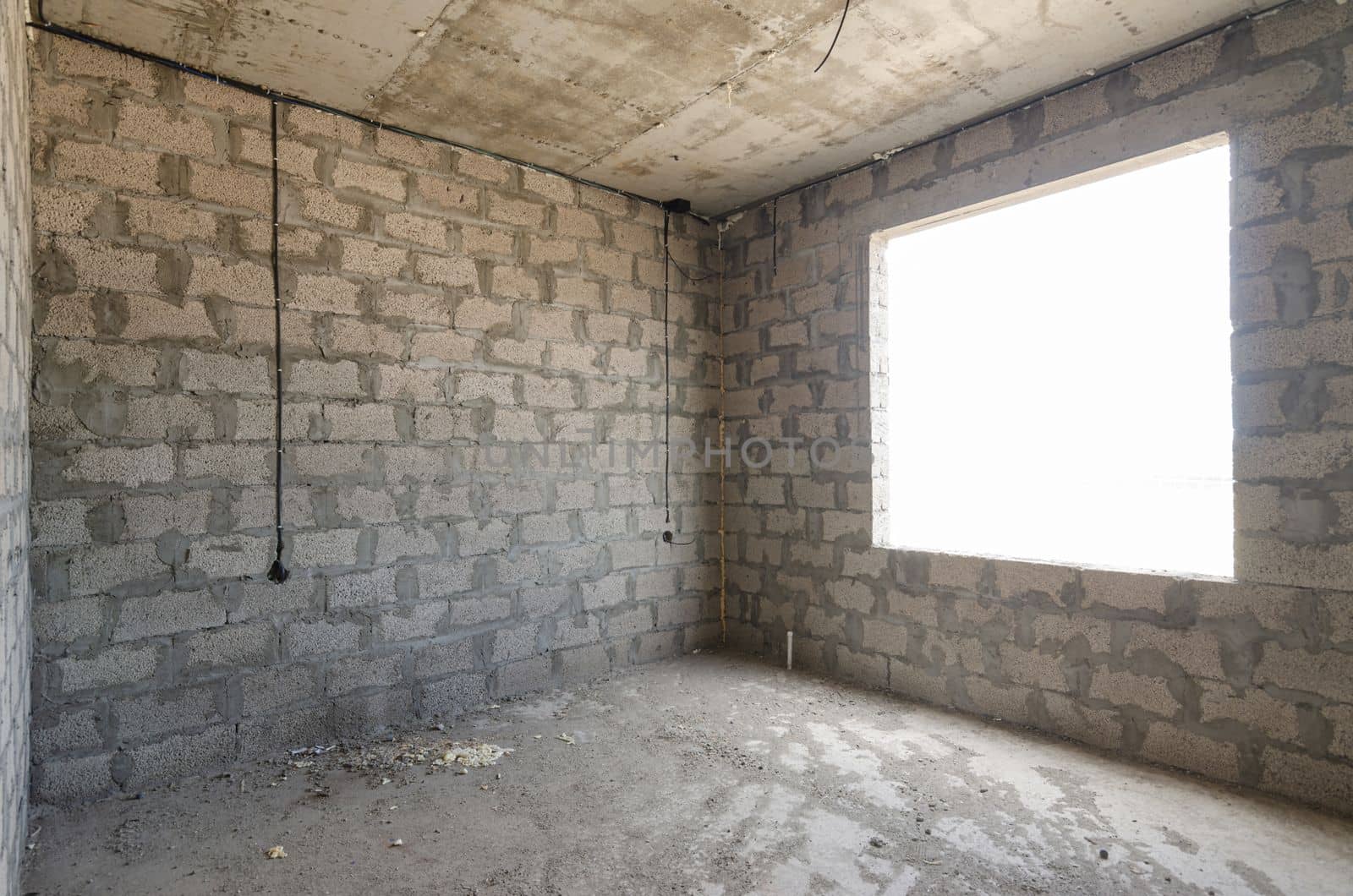 Construction of an individual residential building, view of two walls, blind interior and exterior with a window opening by Madhourse