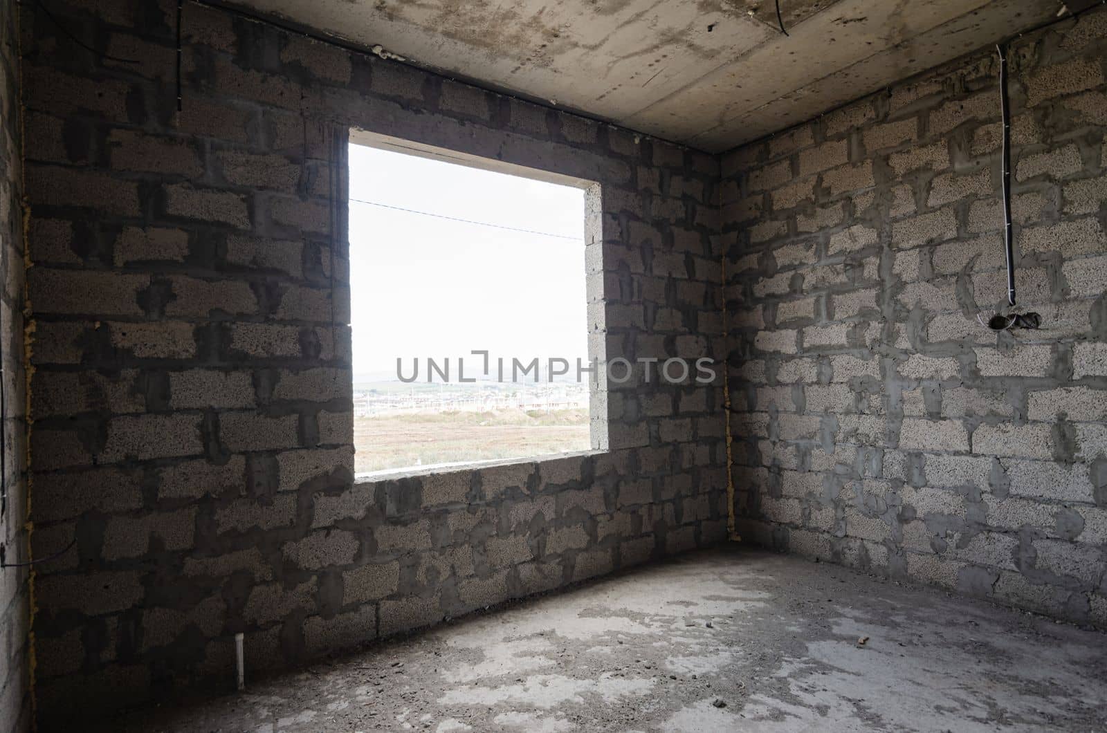 Construction of an individual residential building, wall view with a square large window opening by Madhourse
