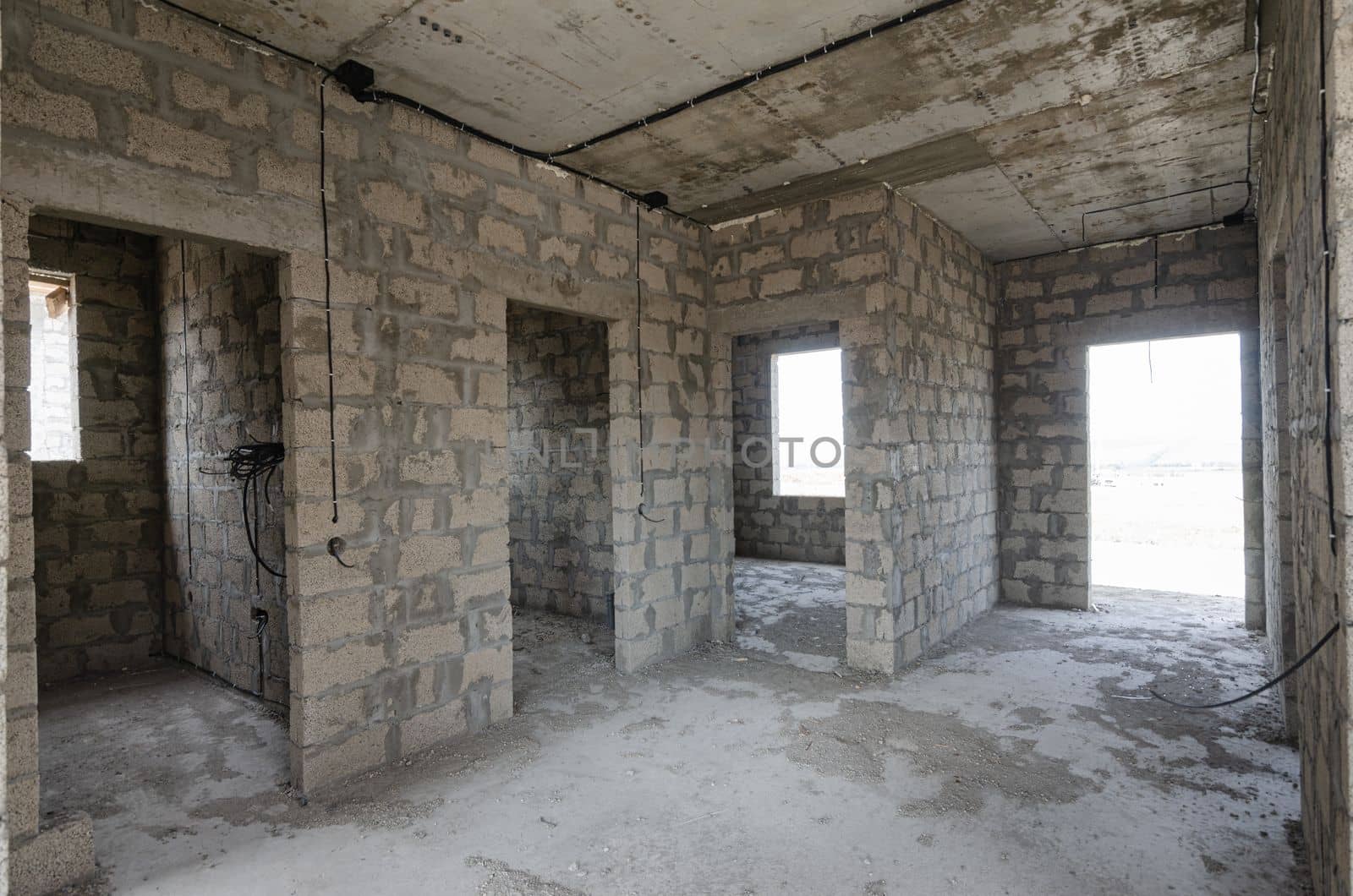 Construction of an individual residential building, view of the front door and doorways to bathrooms and rooms by Madhourse