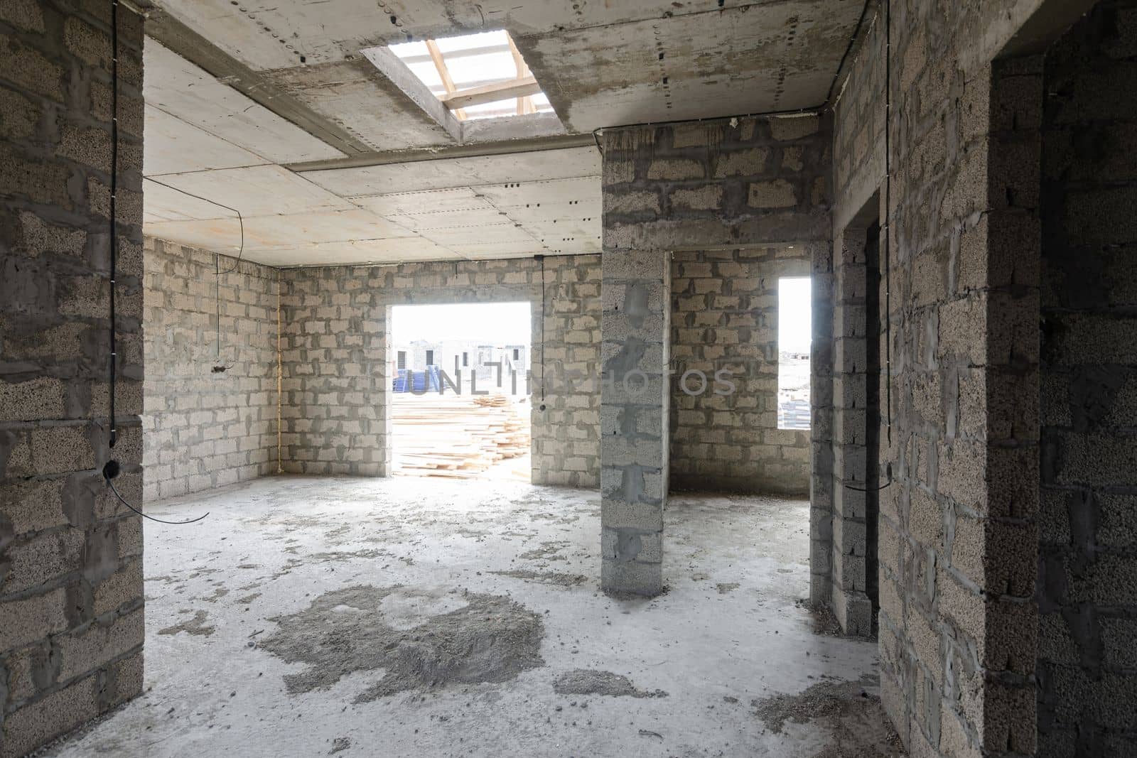 Construction of an individual residential building, view from the corridor to the large hall and doors to the rooms a