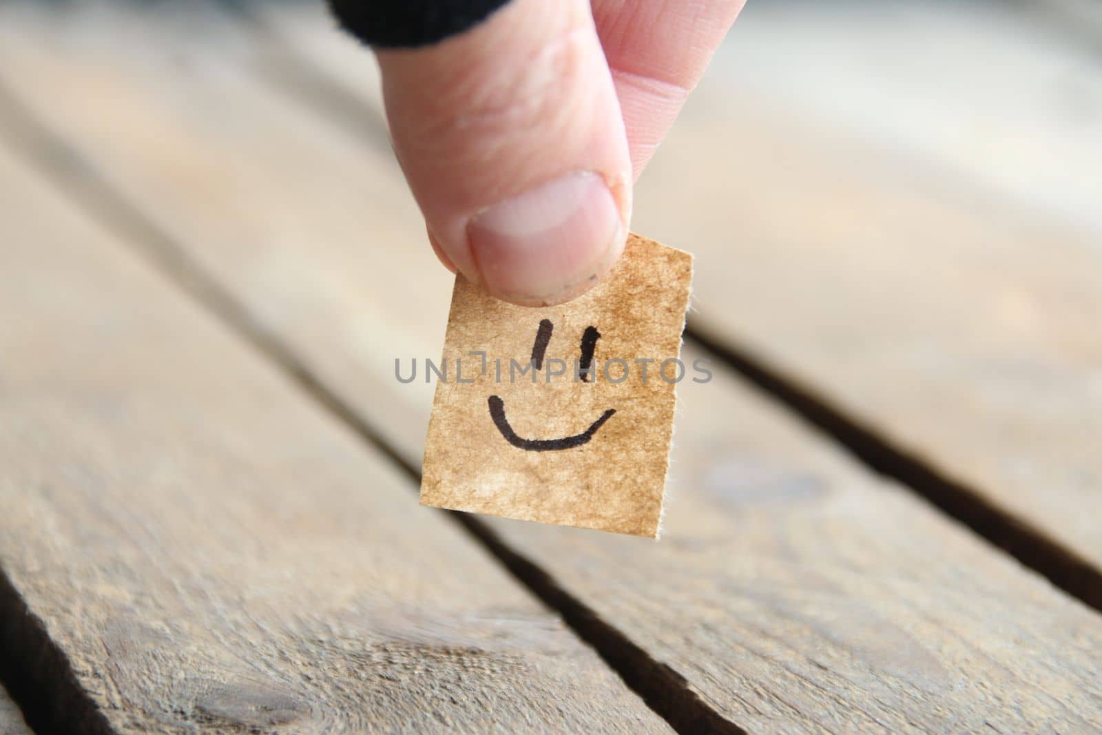 Smiley face on wooden background, copy space. by Markgraf