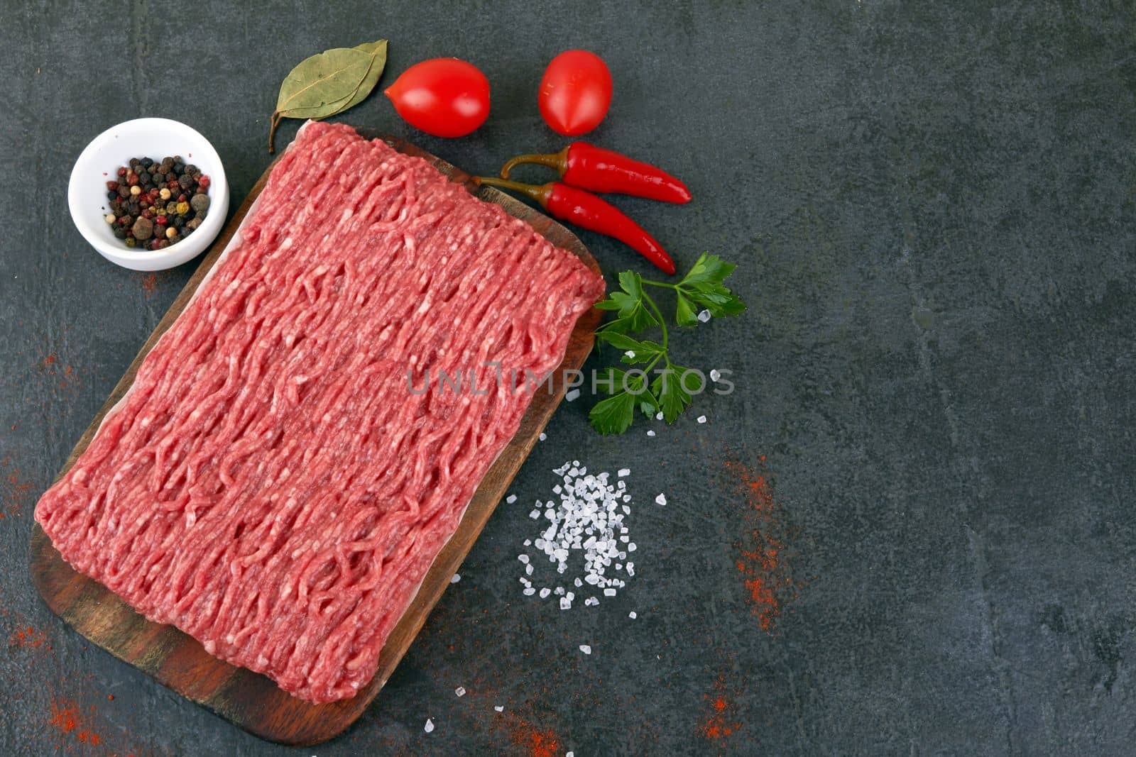 Fresh pork and beef minced meat on a black