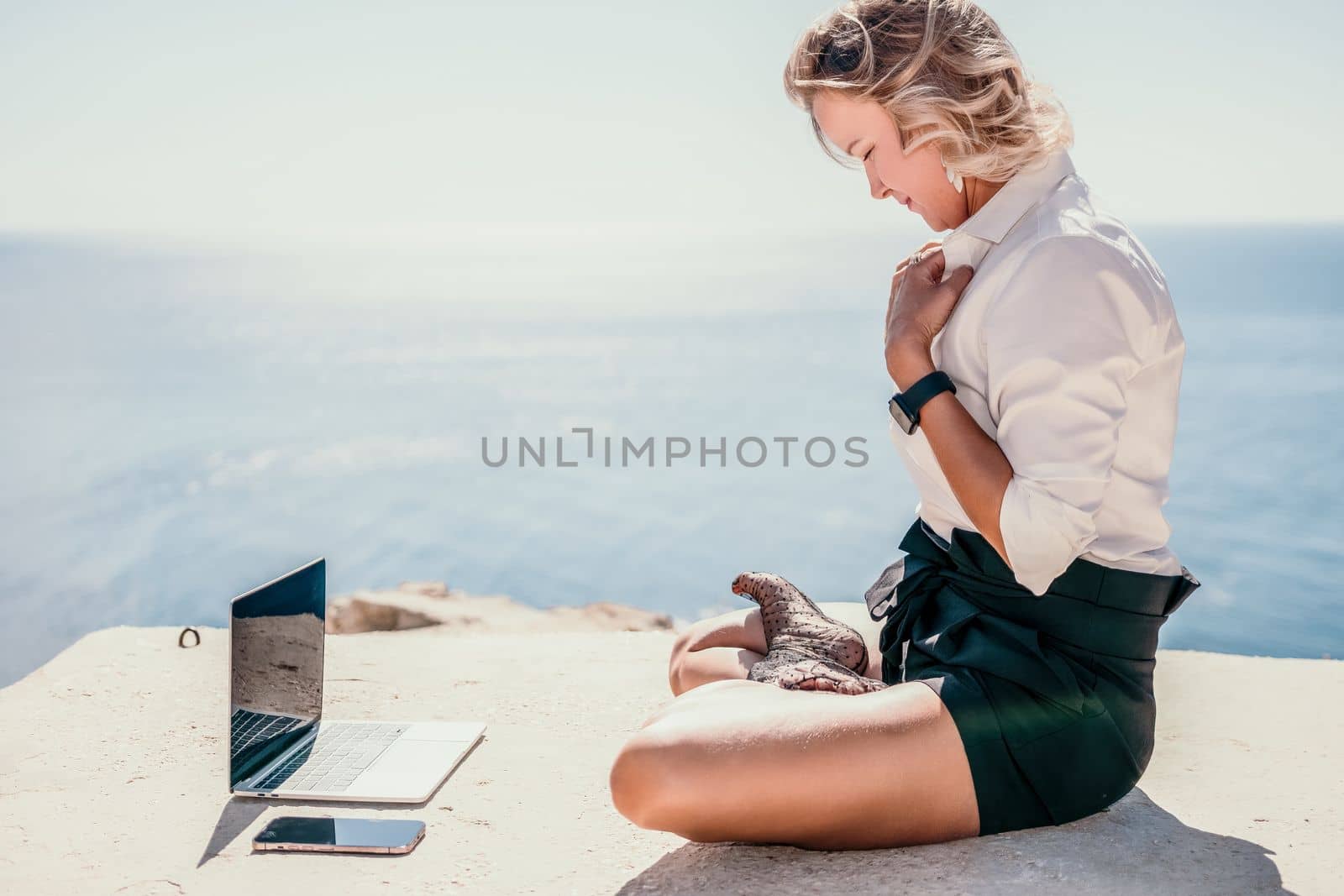 Woman sea laptop yoga. Business woman freelancer in yoga pose working over blue sea beach at laptop and meditates. Girl relieves stress from work. Freelance, digital nomad, travel and holidays concept by panophotograph