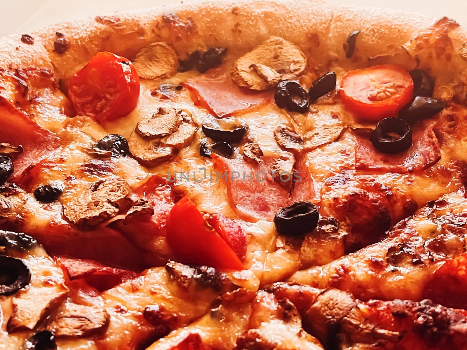Pizza capriciosa in pizzeria, food background by Anneleven