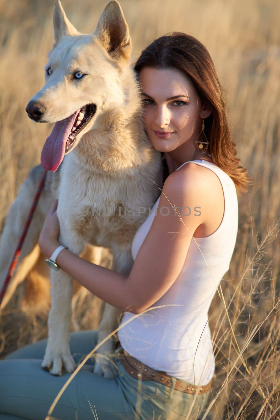 Love is a four-legged word. Portrait of an attractive young woman bonding with her dog outdoors. by YuriArcurs