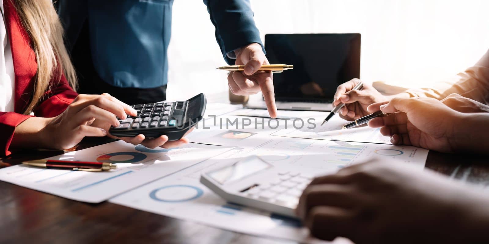 Business team reviewing and analysis a diagram or chart and financial reports for a return on investment or investment risk analysis or business performance by nateemee