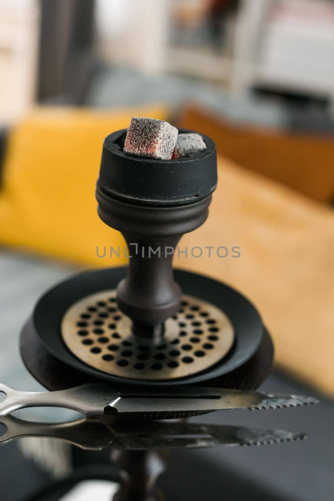 Hookah hot coals for smoking close-up and leisure in natural lighting in room by Satura86