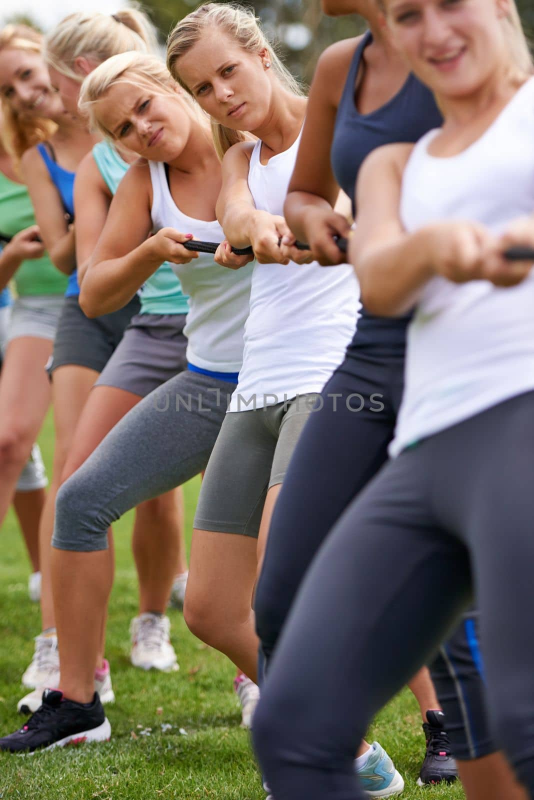 Tug-of-war champs. a girls tug-of-war team training outdoors. by YuriArcurs