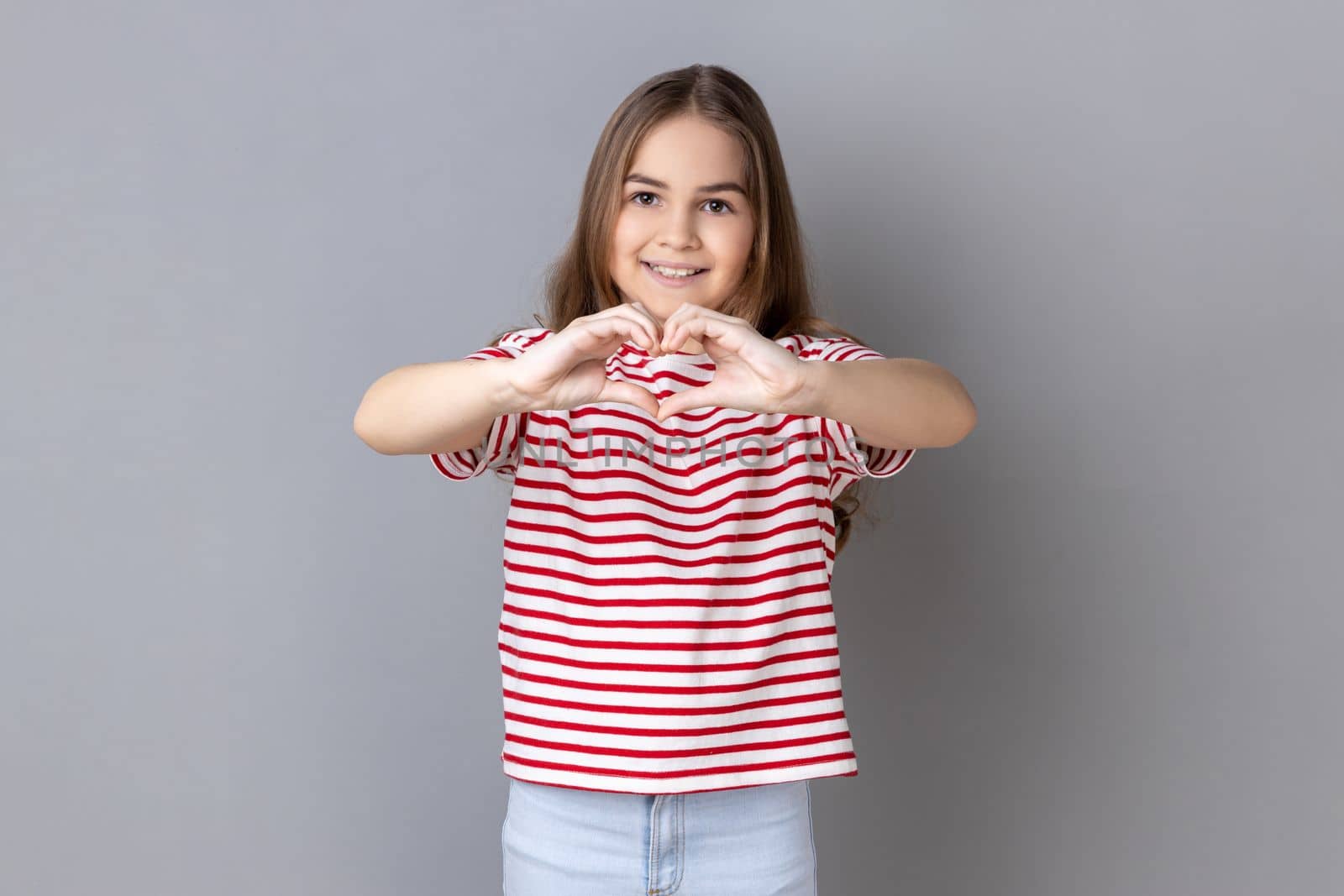 Little girl holding hands in shape of heart showing romantic gesture, love confession. by Khosro1