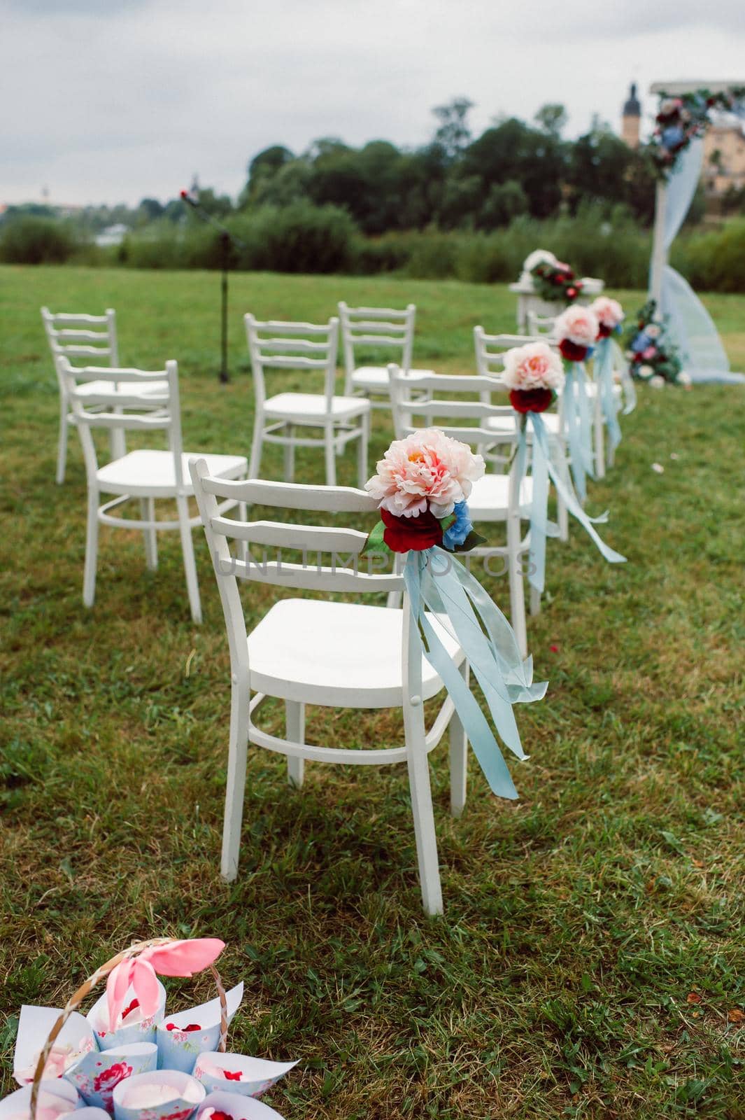 Wedding ceremony on the street on the green lawn.Decor with fresh flowers arches for the ceremony.