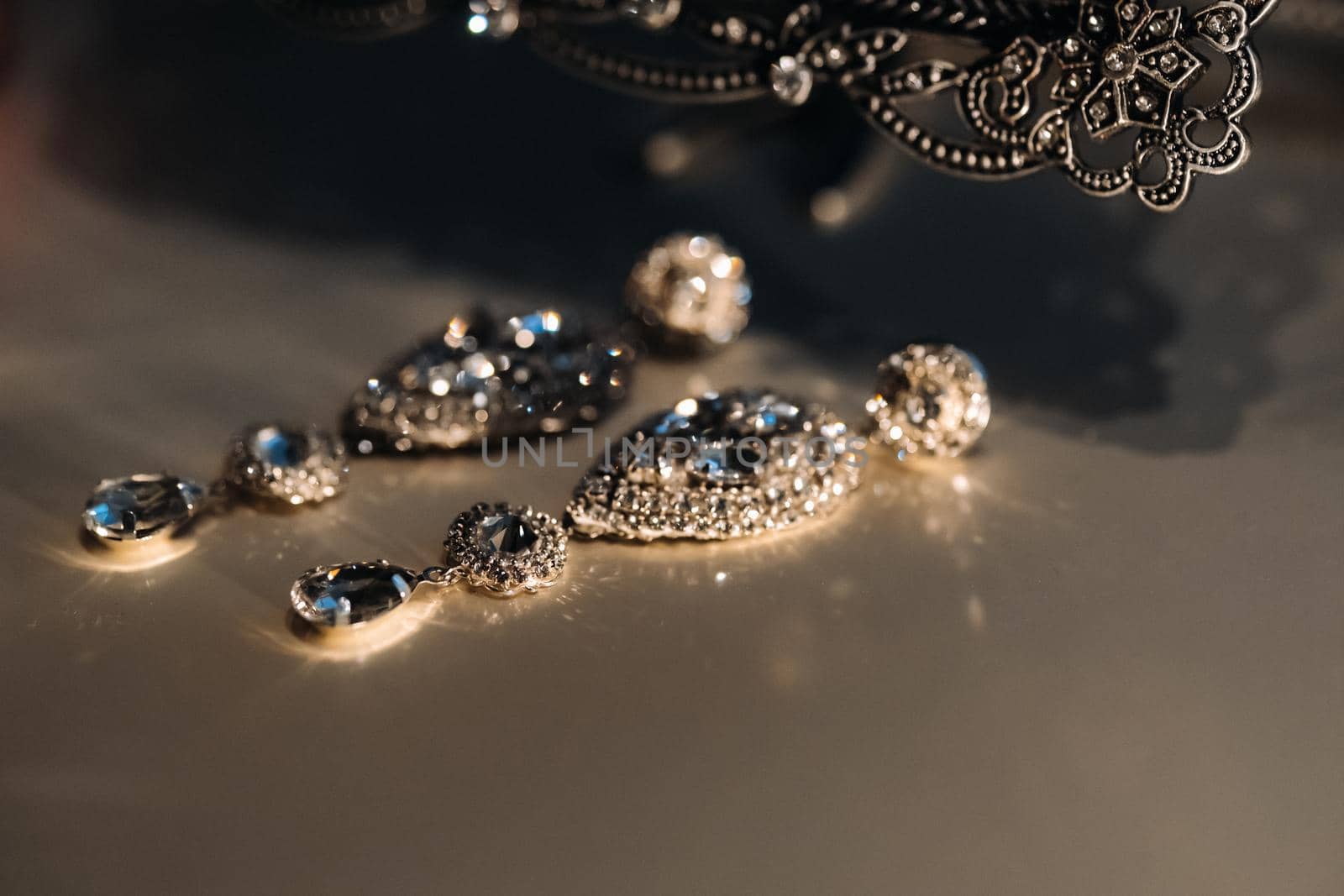 Accessories for the bride. Earrings on the veil. White wedding earrings. Space for text and ads