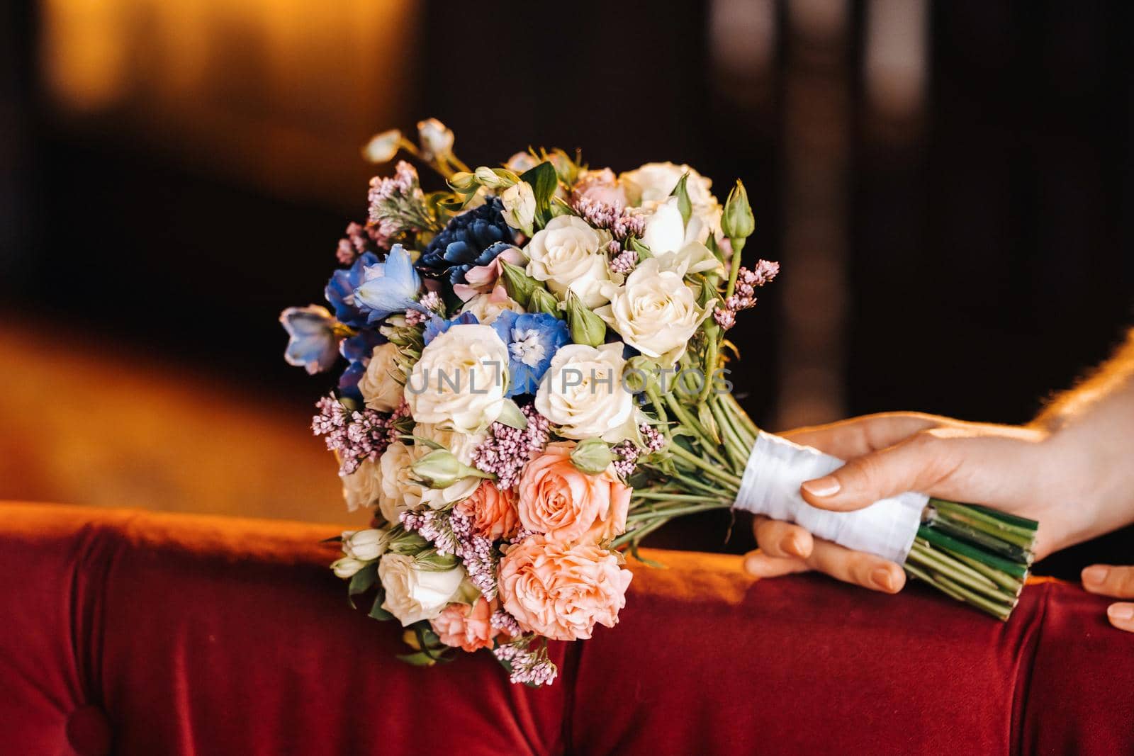 wedding bouquet with peonies in the hands of the bride under the veil.Morning of the bride.