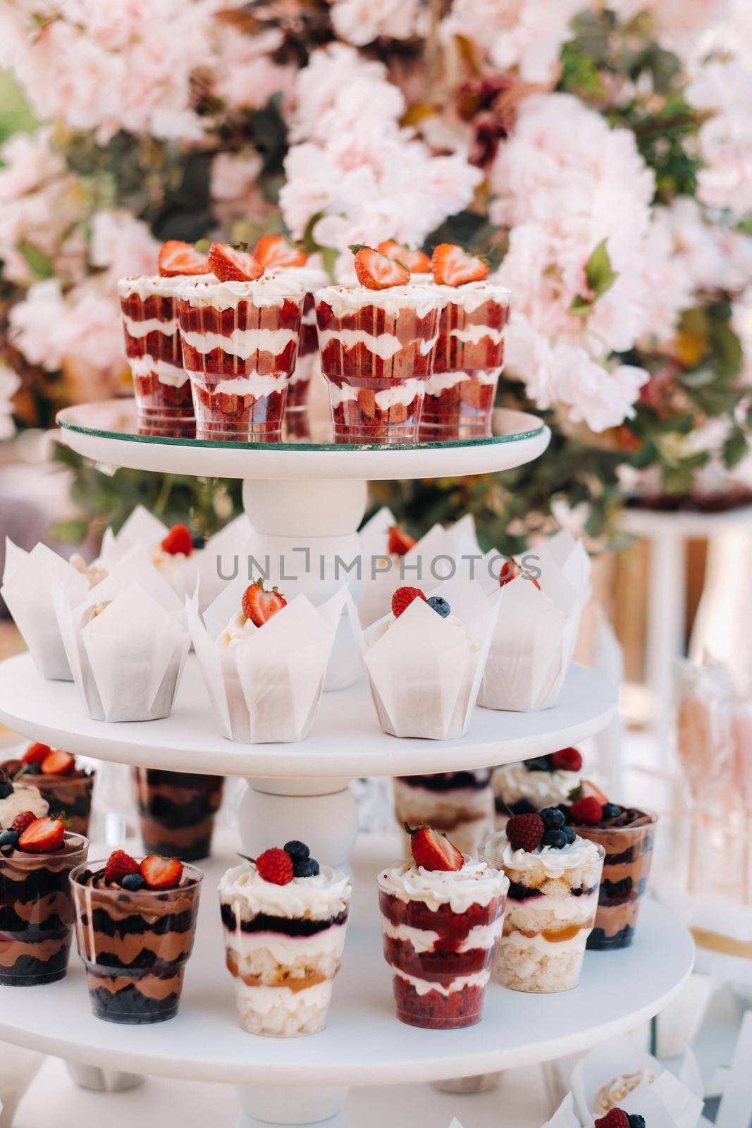 Sweet table at the wedding. Table with cakes and sweets at the festival by Lobachad